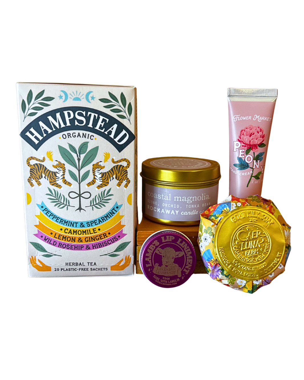 Self Care Essentials gift bundle with Hampstead organic herbal tea, Rockaway coastal magnolia candle, Flower Market peony hand cream, Lamb's lip balm and Caer Luna goat milk soap from CLUTCH Market Greenwich NY