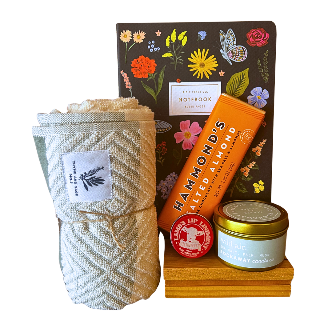 Sweet and Simple gift bundle with Rockaway wild air candle, Rifle Paper Co notebook, Hammond's salted almond chocolate bar, Lamb's strawberry lip balm and Thyme and Sage woven dish towel from CLUTCH Market Greenwich NY